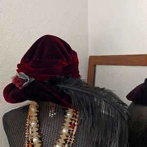 Velvet Burgundy Hat with Flower and Feather Accent.